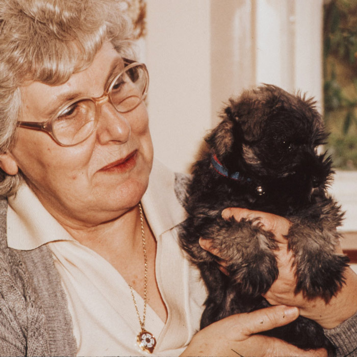 elderly lady holding a cute dog