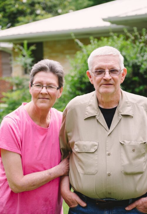 older couple standing outside together
