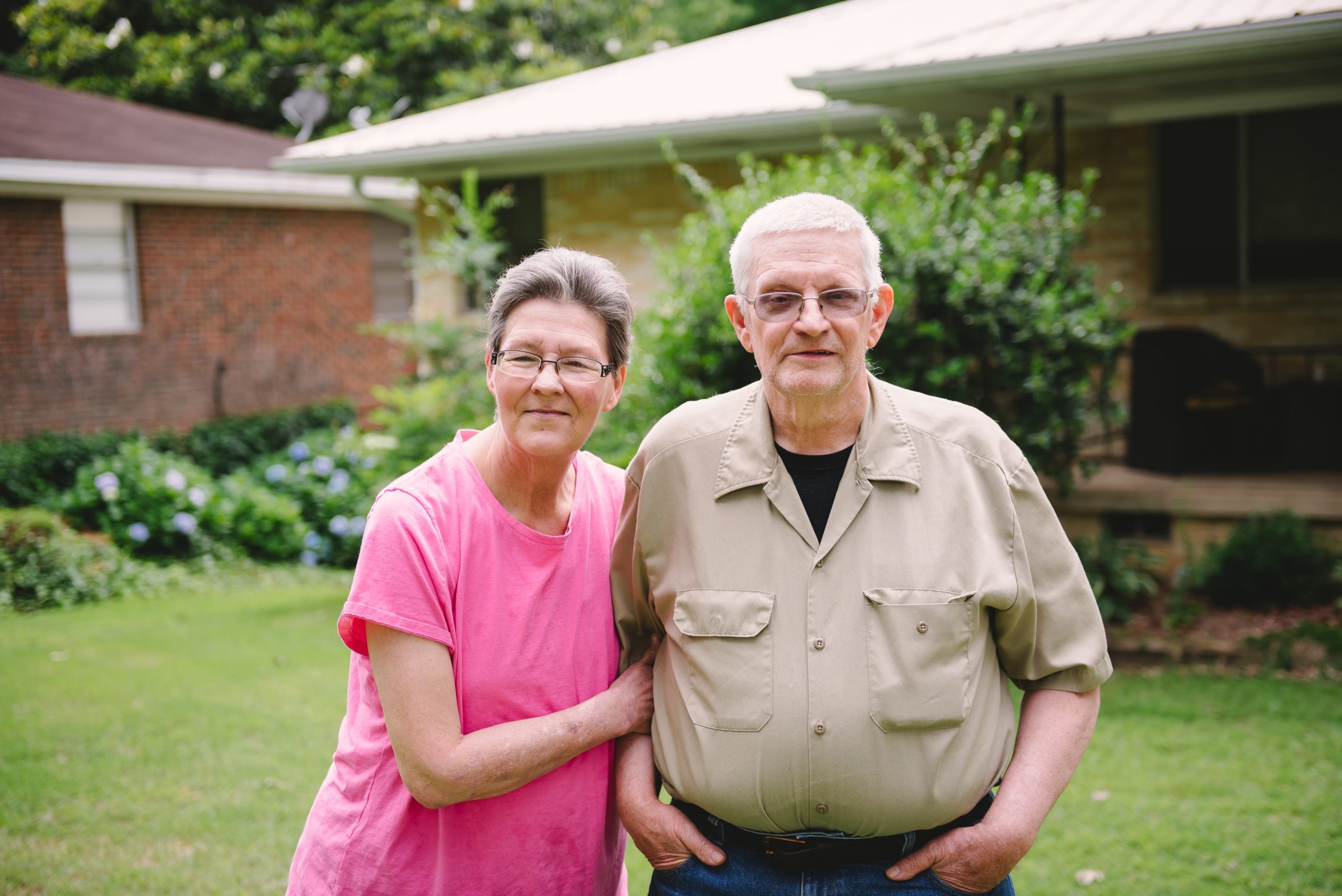 older couple standing outside together