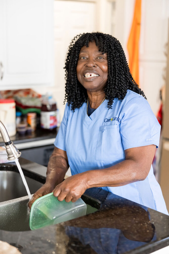 CareLink caregiver washing dishes