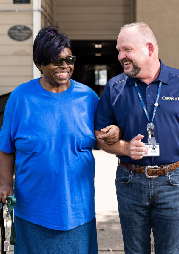 transportation driver escorting senior woman to the CareLink van