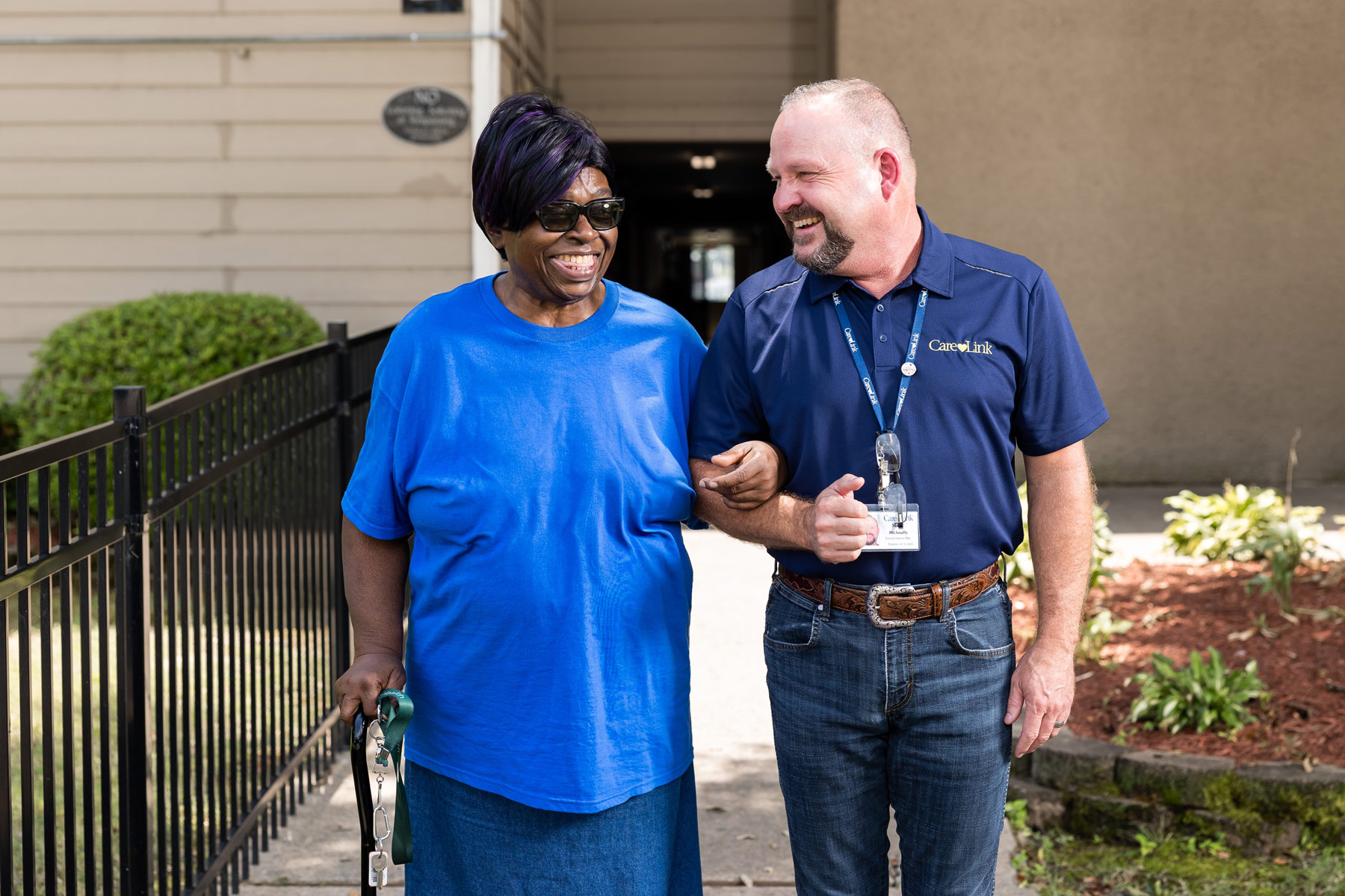 transportation driver escorting senior woman to the CareLink van