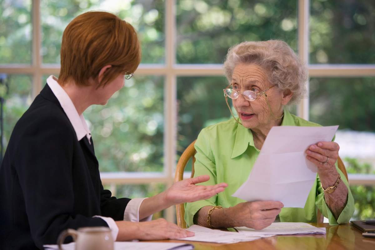 A senior woman speaking with a advisor.