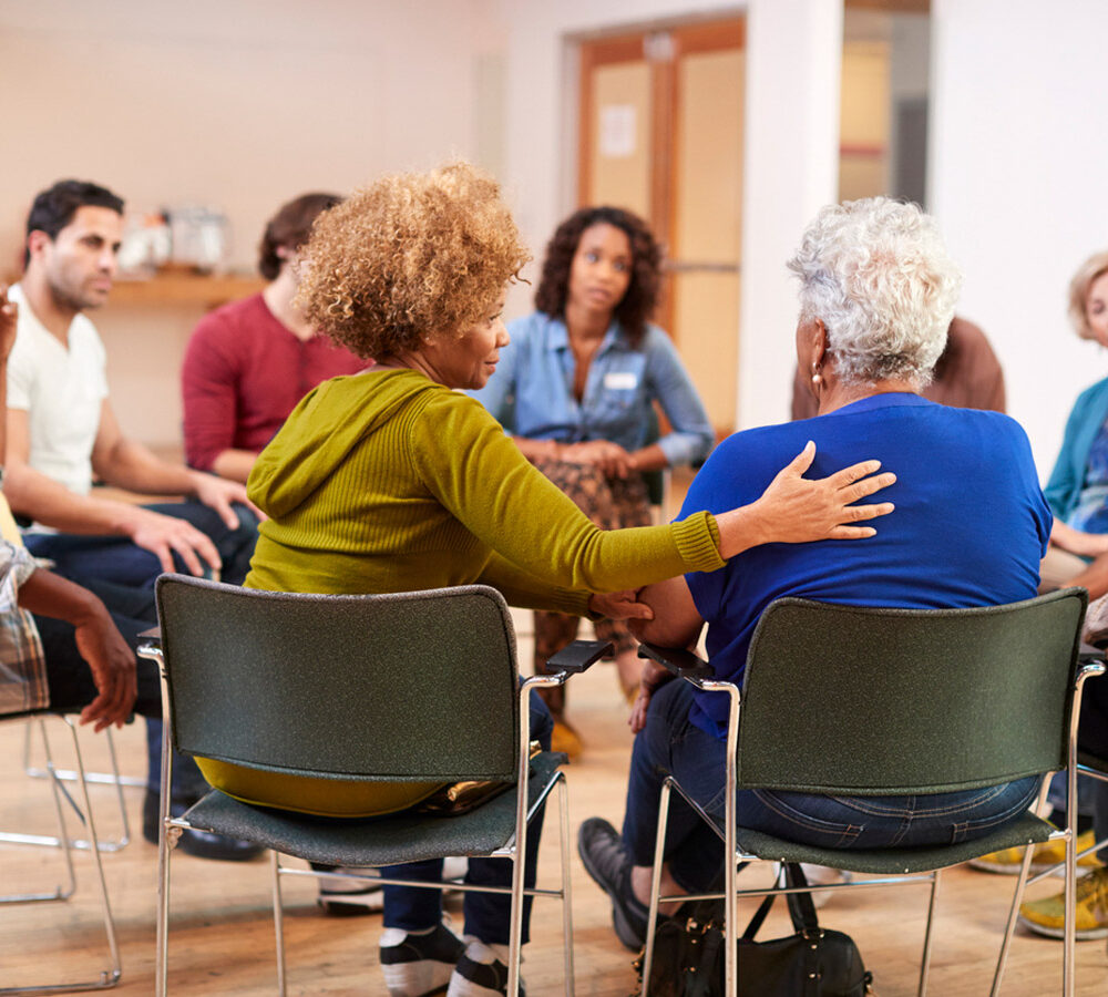 People Attending Group Meeting In Community Center