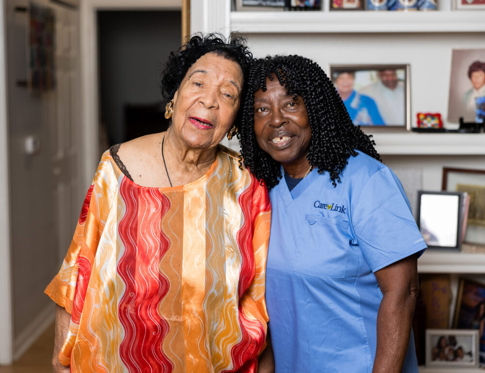 an elderly woman with her caregiver