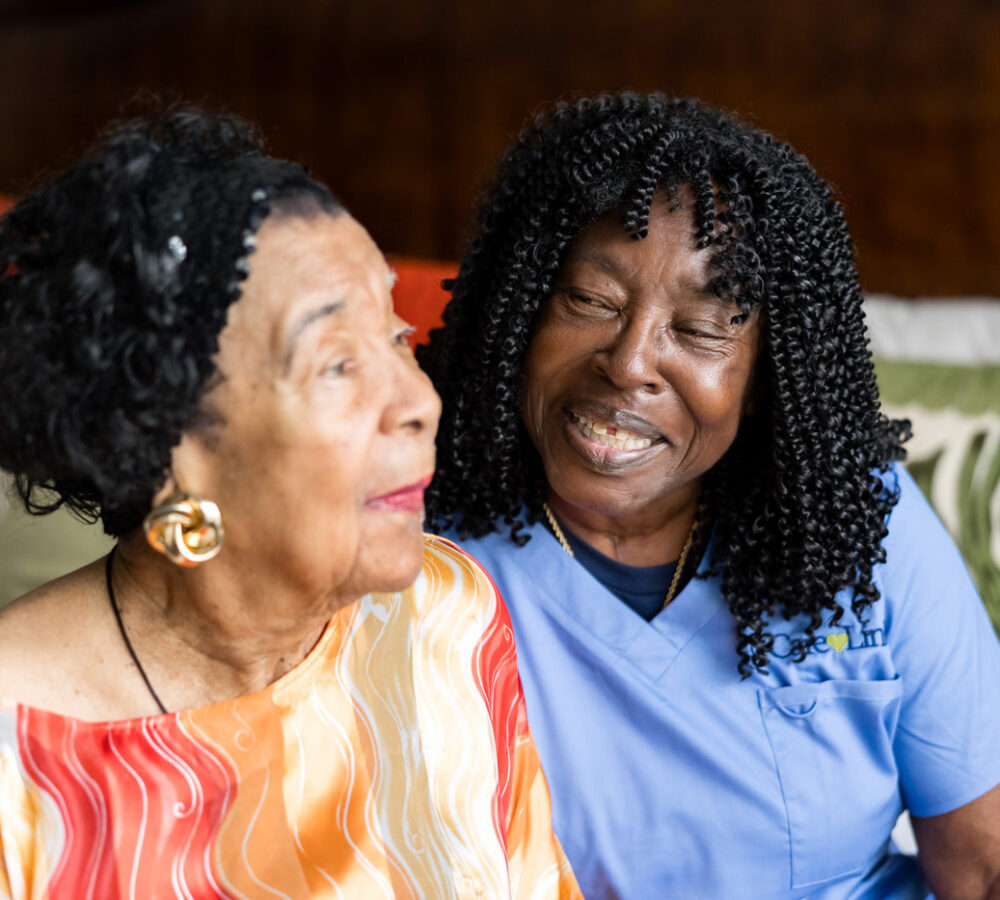 an elderly woman with her caregiver