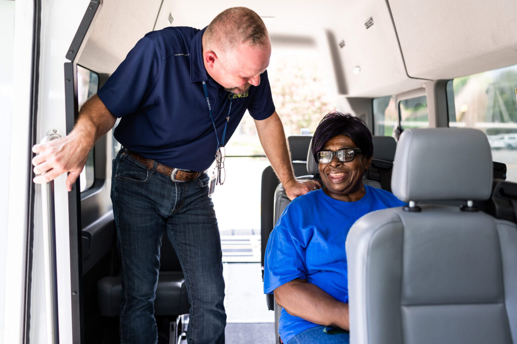 passenger and driver smiling inside the non-emergency medical transportation van