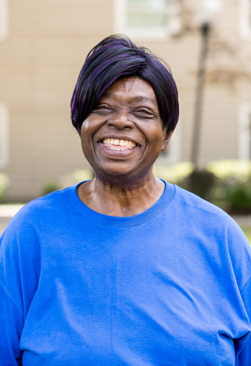 smiling older woman standing outside
