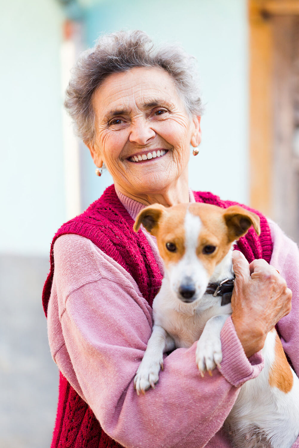 senior woman holding her small dog